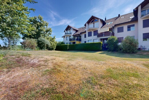 outdoor house with a yard and stucco siding