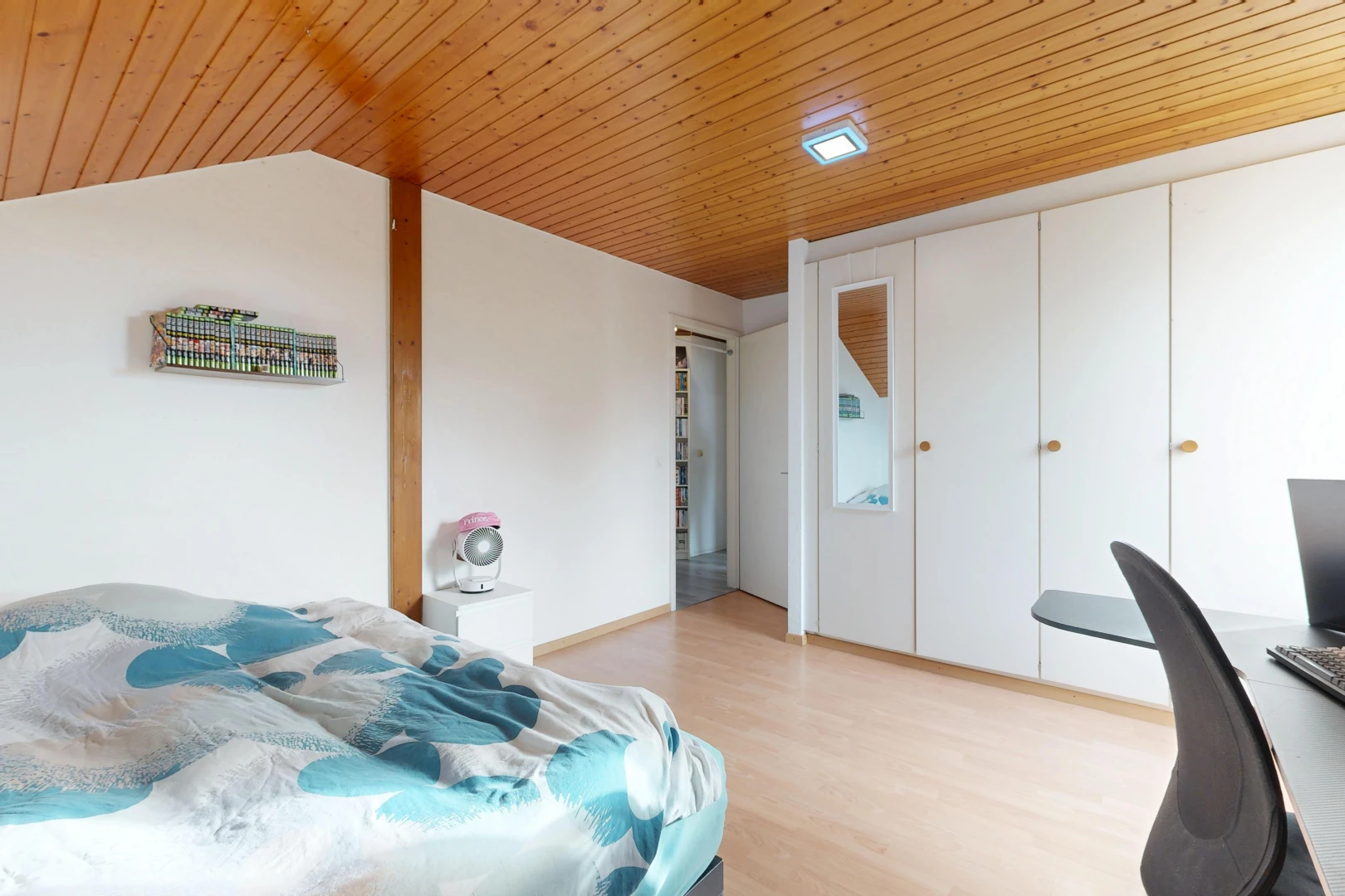 room / bedroom featuring a vaulted wood ceiling, a desk, a closet, and light wood finished floors