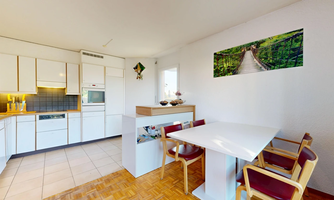 kitchen with breakfast area, white cabinetry, light countertops, and oven