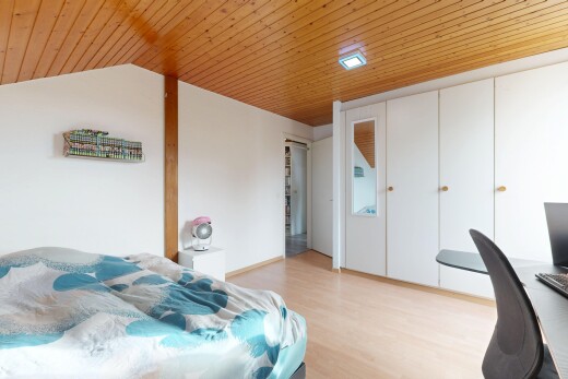 room / bedroom featuring a vaulted wood ceiling, a desk, a closet, and light wood finished floors