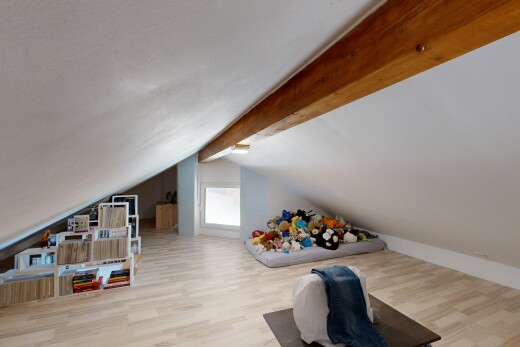 room / bedroom with light wood-type flooring and beamed ceiling
