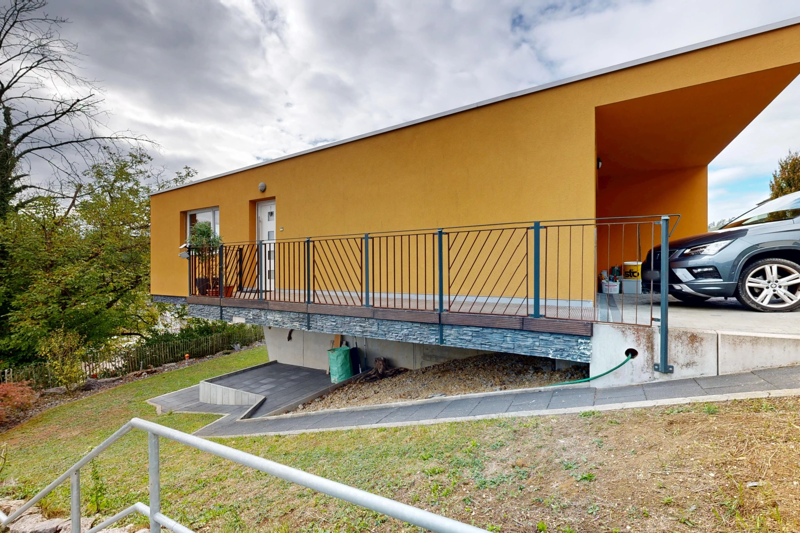 outdoor house featuring stucco siding and a lawn