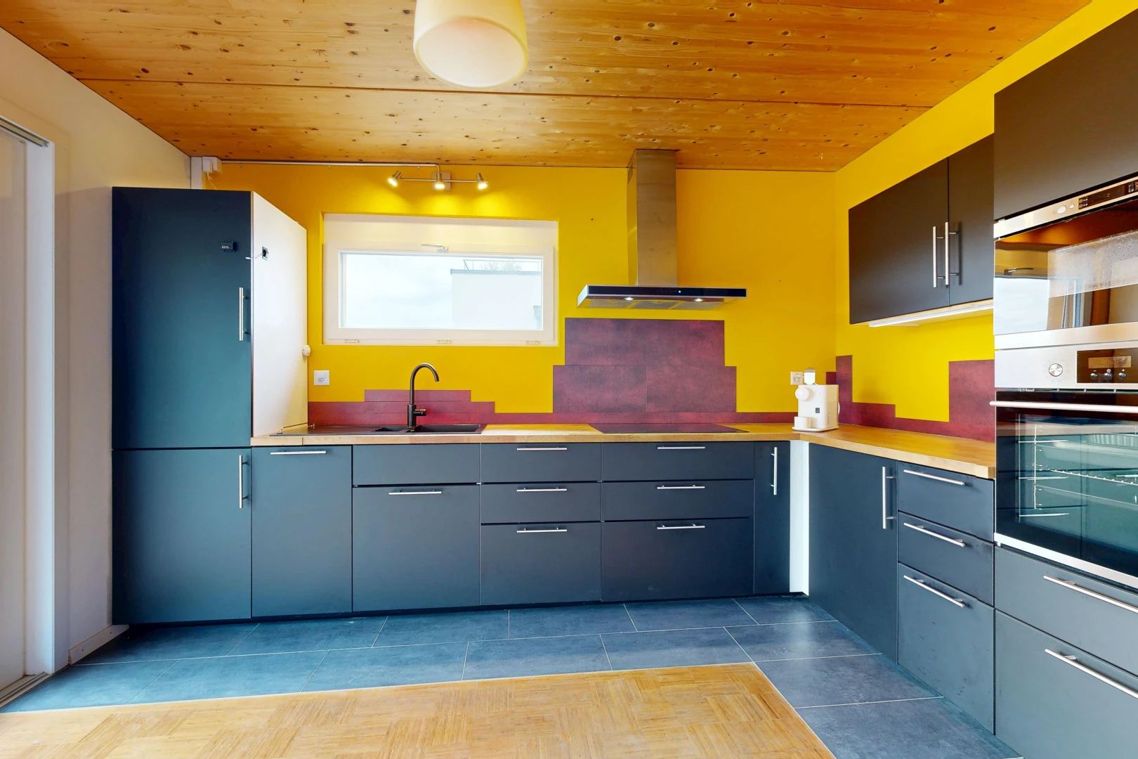 kitchen with wood ceiling, oven, light countertops, and black electric stovetop