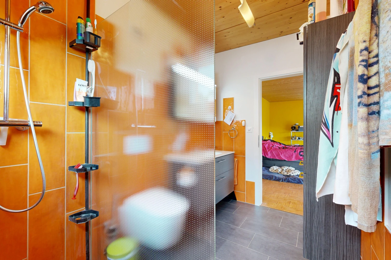 ensuite bathroom with a tile shower and wooden ceiling