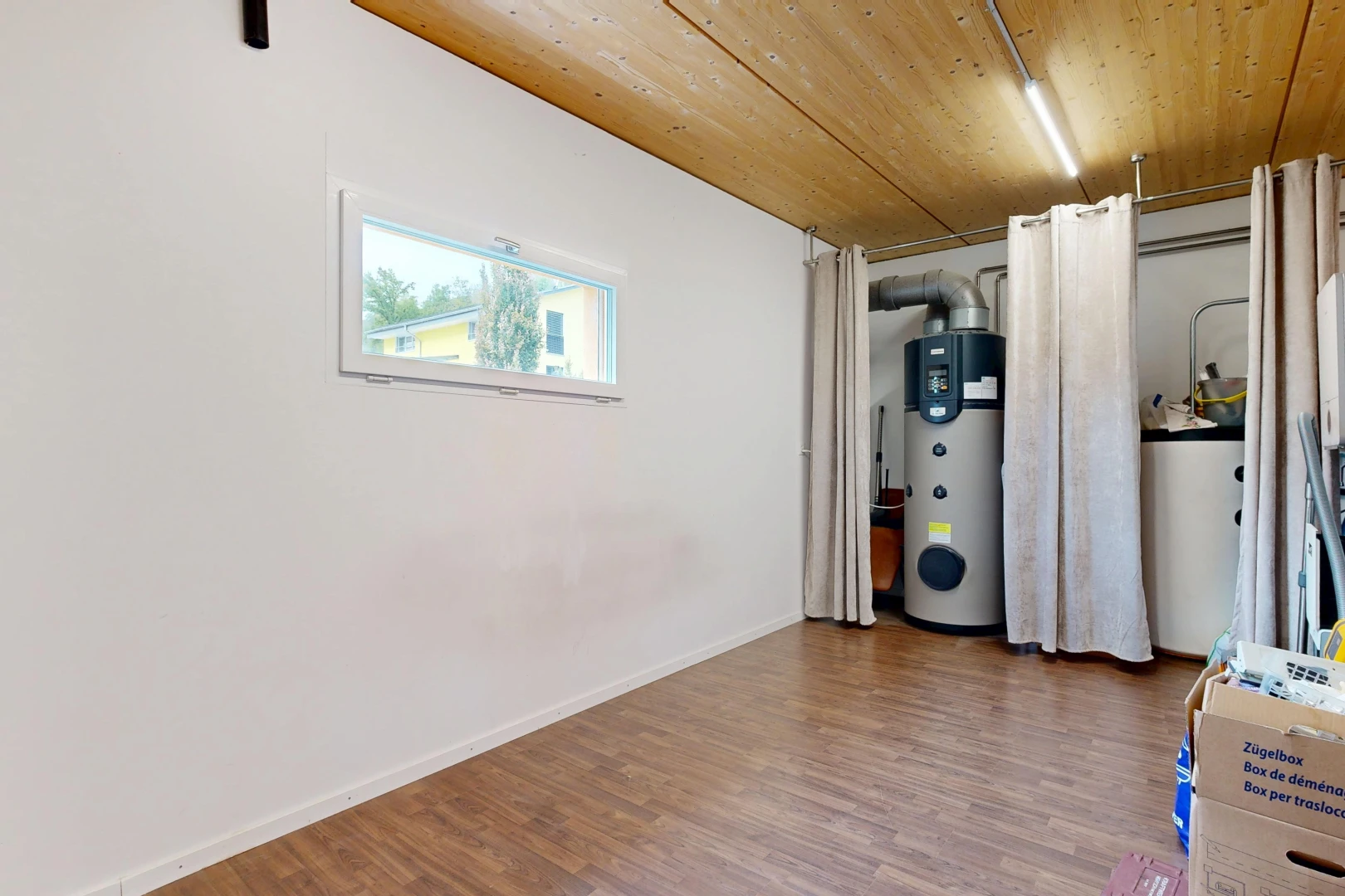 laundry area featuring wooden ceiling, heat pump water heater, wood finished floors, and gas water heater