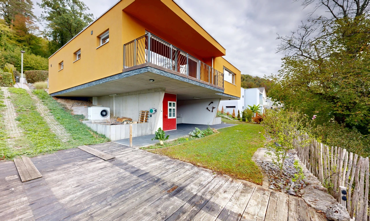 view of home with a balcony and stucco siding