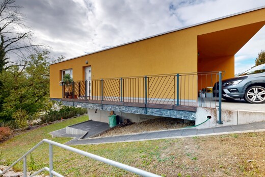 outdoor house featuring stucco siding and a lawn