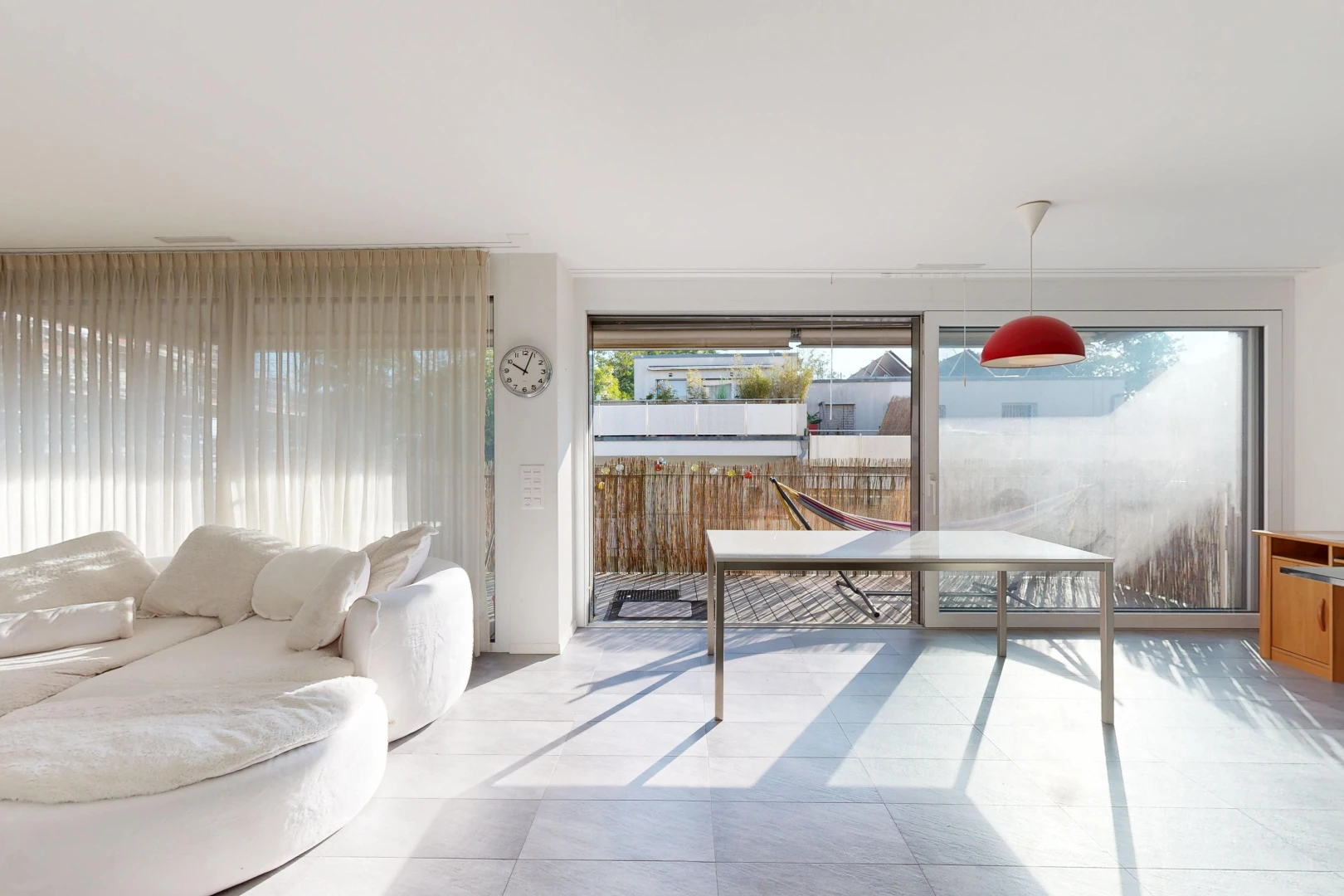 living room with hanging light fixtures, access to outside, and light tile patterned floors