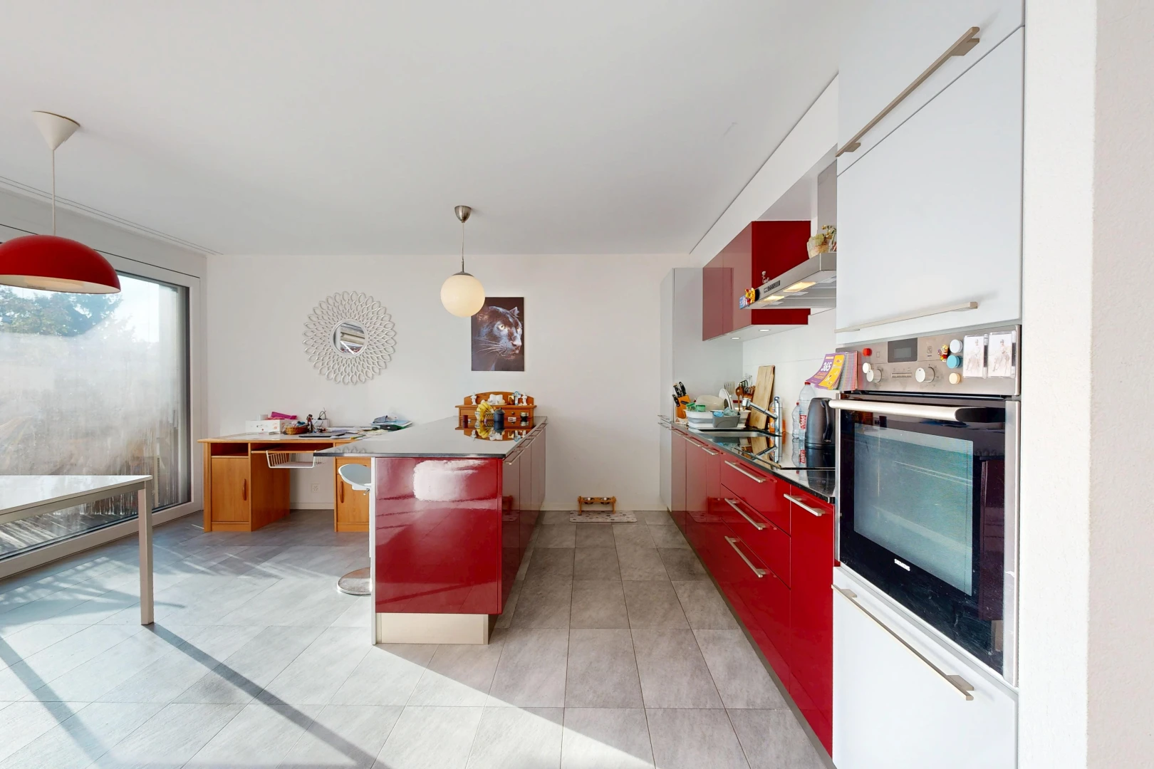 dual tone kitchen featuring oven, hanging light fixtures, a peninsula, modern cabinets, and two tone cabinetry