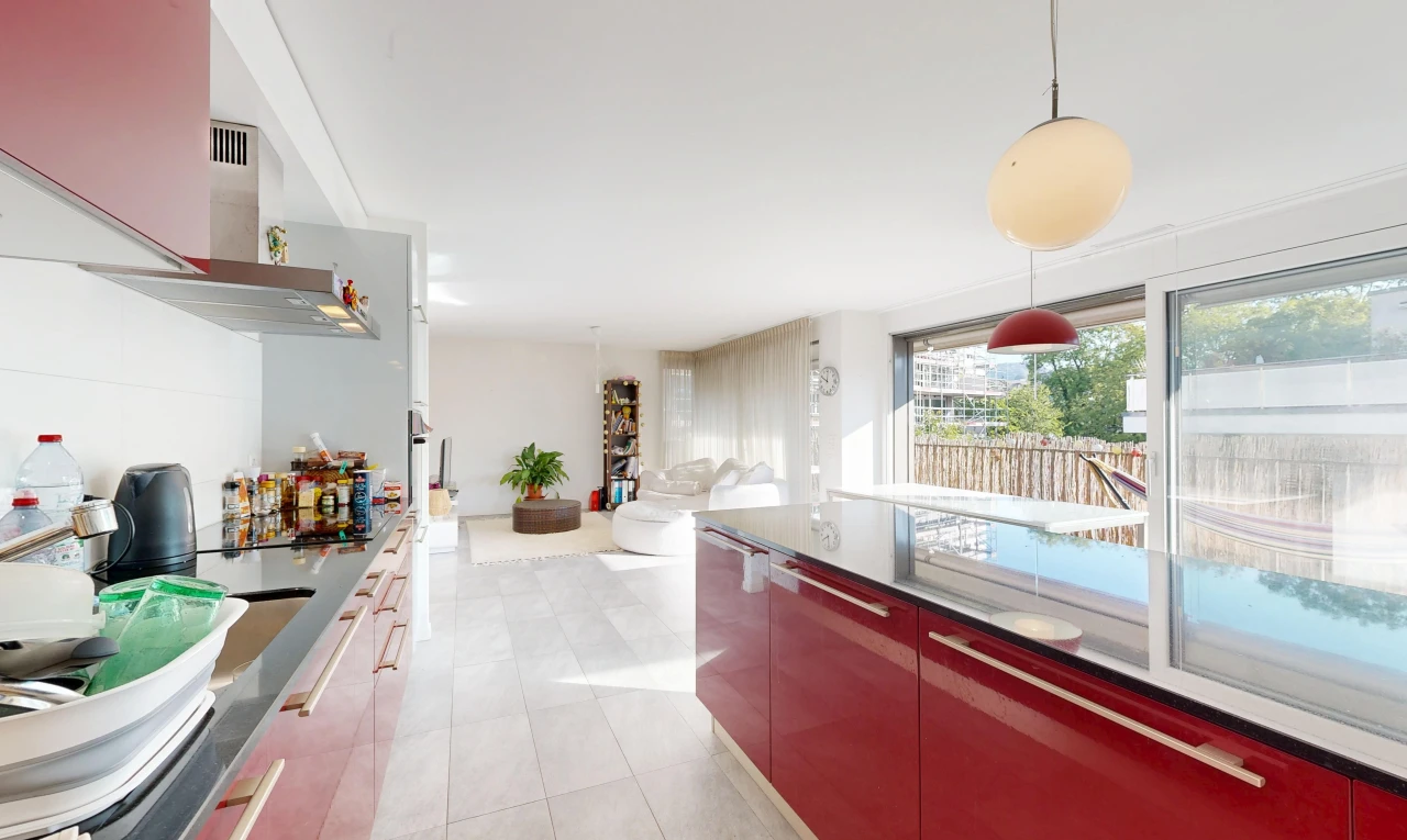 kitchen featuring dark countertops, pendant lighting, open floor plan, modern cabinets, and light tile patterned flooring