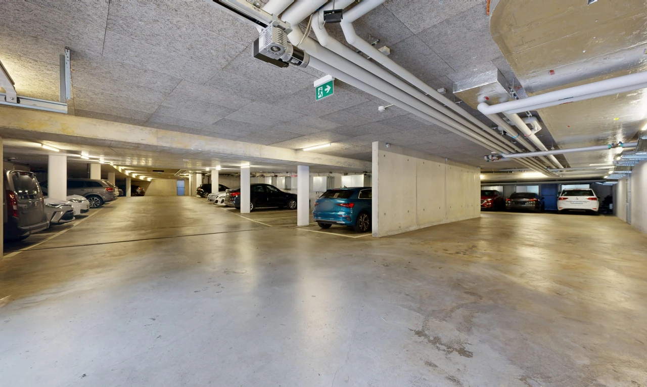view of parking with a parking garage