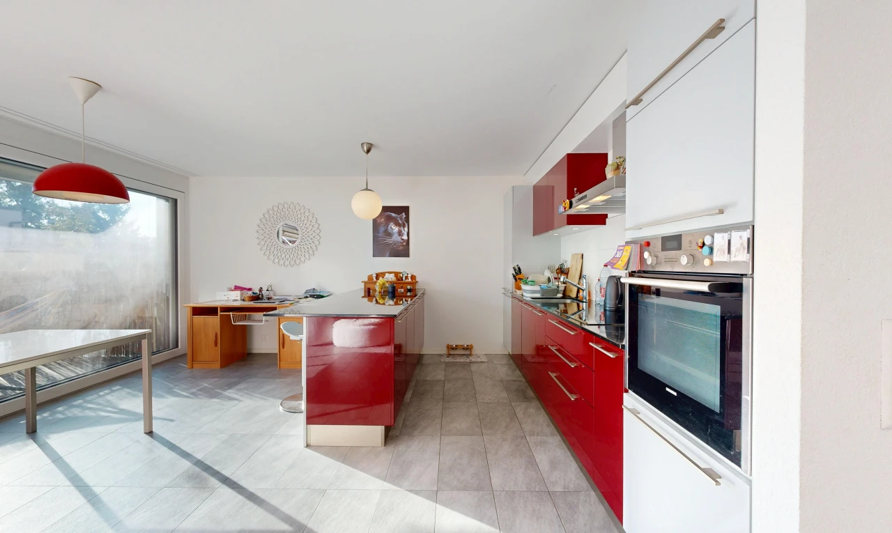 dual tone kitchen featuring oven, hanging light fixtures, a peninsula, modern cabinets, and two tone cabinetry