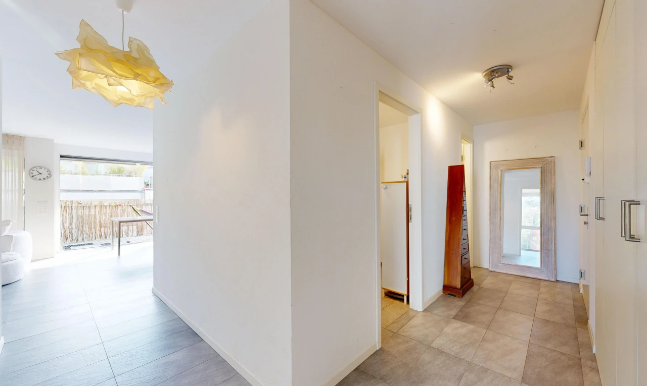 hall with light tile patterned flooring