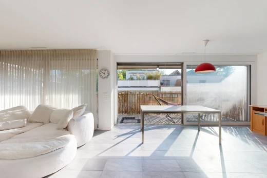 living room with hanging light fixtures, access to outside, and light tile patterned floors