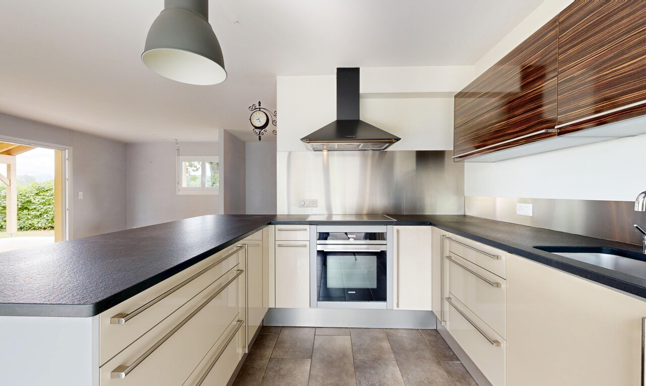 cuisine avec hotte, plans de travail, dark countertops, four, et péninsule de cuisine