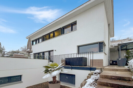 snow covered house with stucco siding