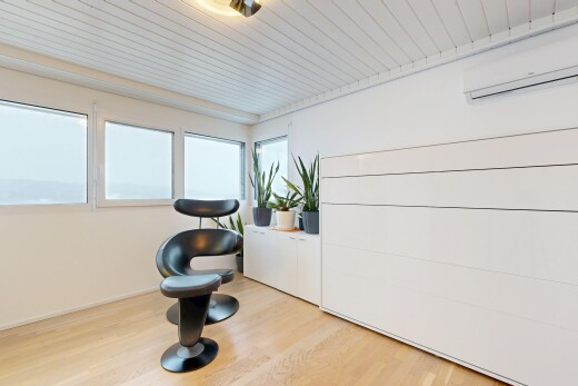 exercise room featuring an AC wall unit, wood finished floors, and wooden ceiling