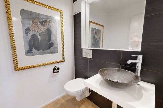 half bath featuring a sink and tile walls