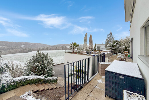 view of snow covered back of property