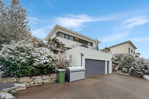 outdoor house with stucco siding, driveway, and a garage