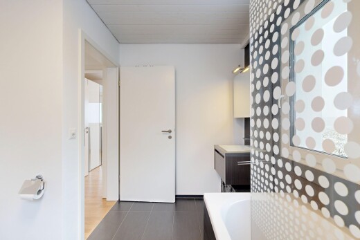 bathroom with dark tile patterned flooring and vanity