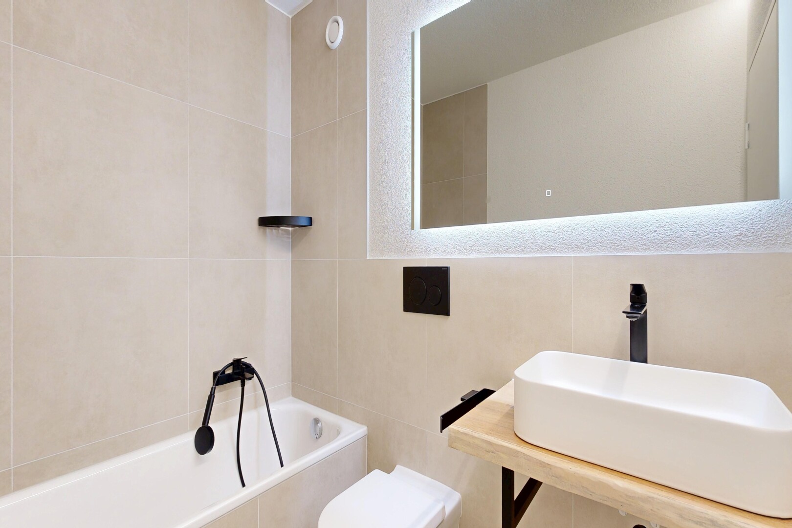 bathroom with tile walls and a garden tub