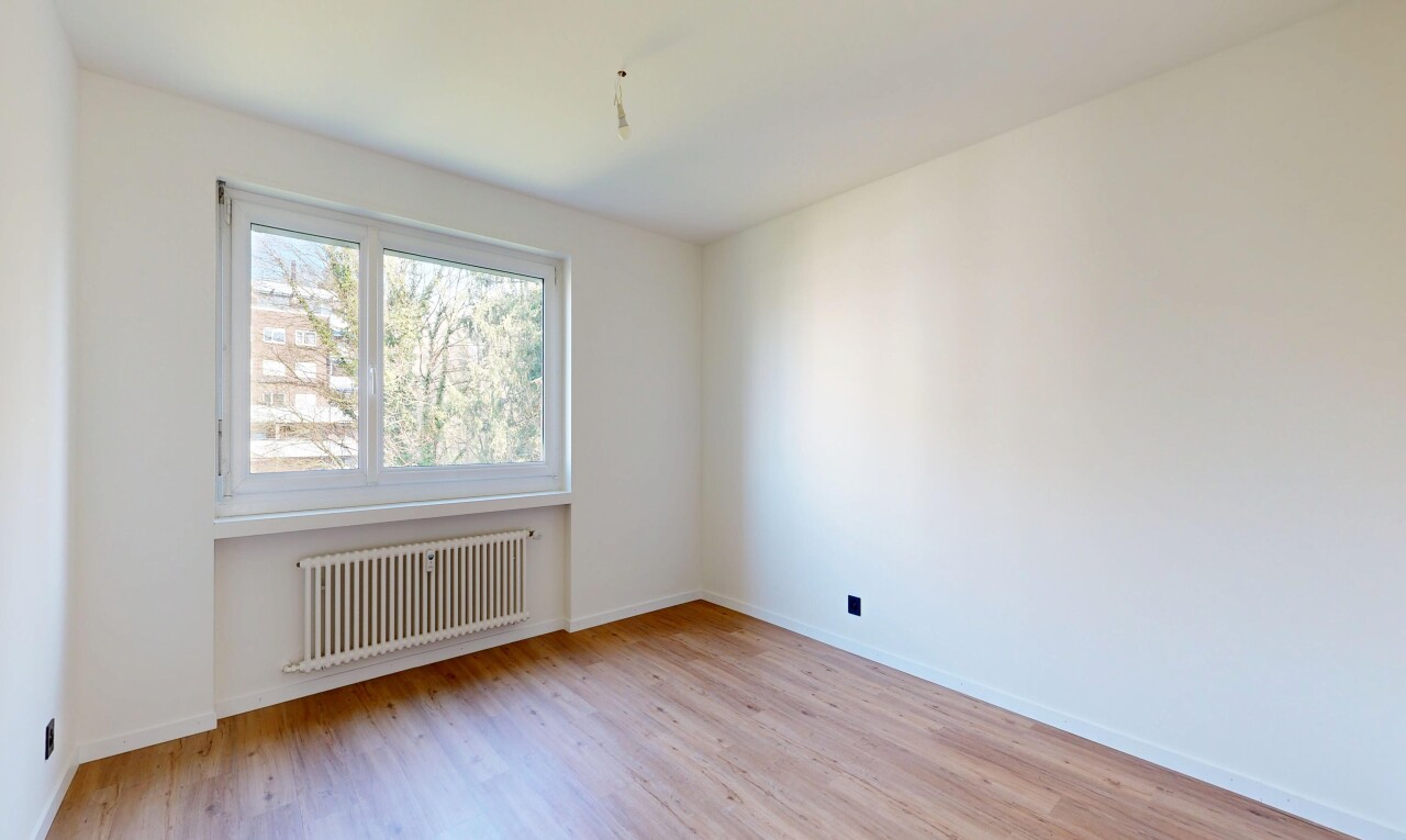 spare room featuring radiator and light wood-type flooring