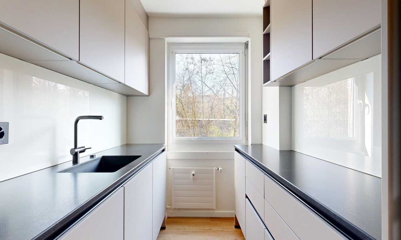 kitchen featuring dark countertops and white cabinets