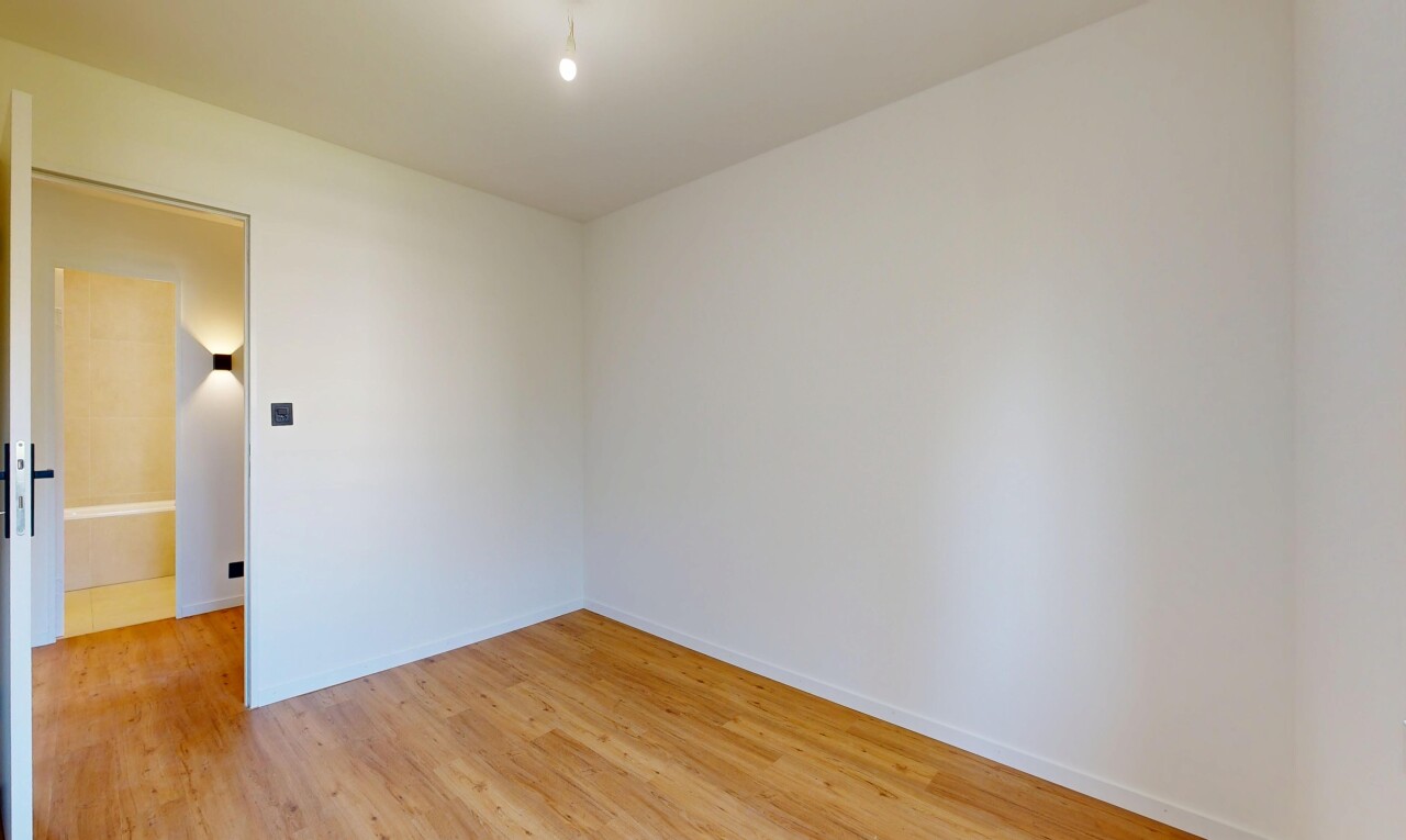 unfurnished room featuring light wood-type flooring and baseboards