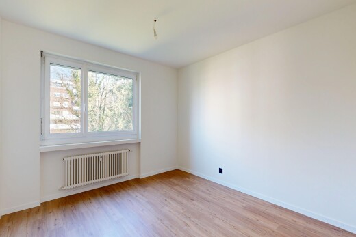 spare room featuring radiator and light wood-type flooring