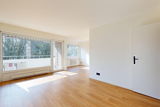 unfurnished room with light wood-type flooring and a baseboard radiator