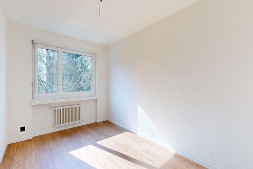 spare room with radiator heating unit and light wood-type flooring