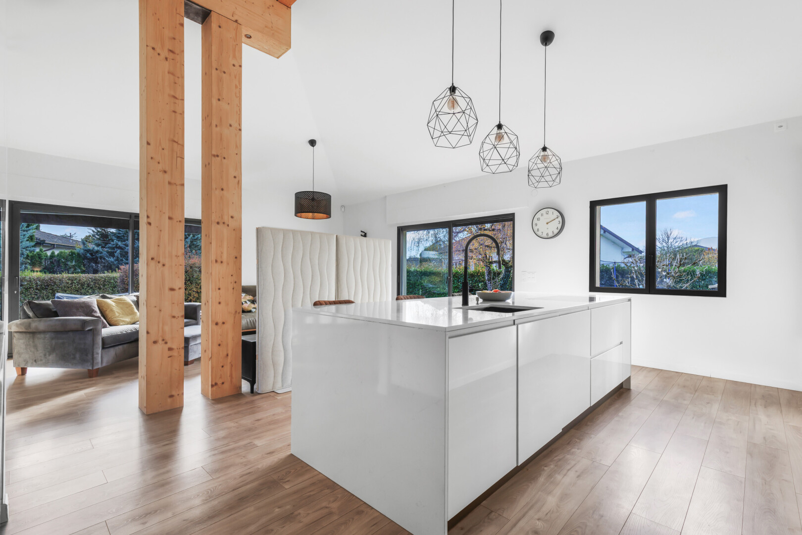 küche mit schränke mit flachen paneelen, pendelleuchte, weiße schränke, wood finish floor, und holzfußboden