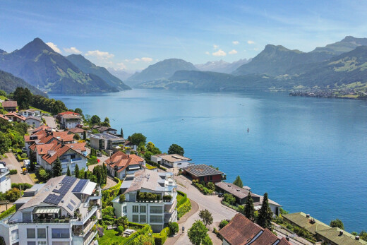 water view with a mountainous background and nearby suburban area