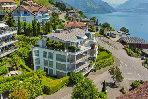 outdoor house with a balcony and a water and mountain view