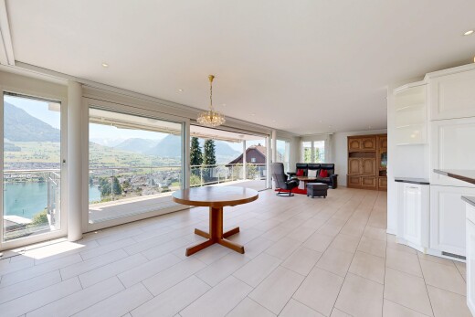 living room featuring floor to ceiling windows and a water and mountain view