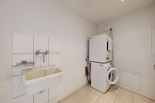 laundry area with stacked washer and dryer