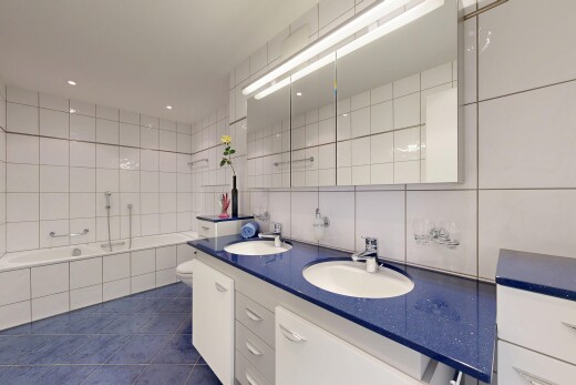 kitchen featuring white cabinetry, tile walls, dark tile patterned flooring, dark countertops, and recessed lighting