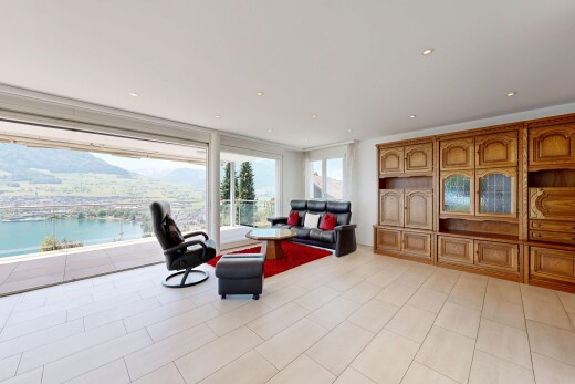 living room with a water view, recessed lighting, and expansive windows