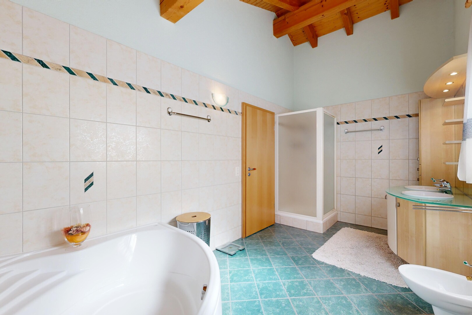 bathroom featuring a shower stall, vanity, a bidet, tile walls, and a garden tub