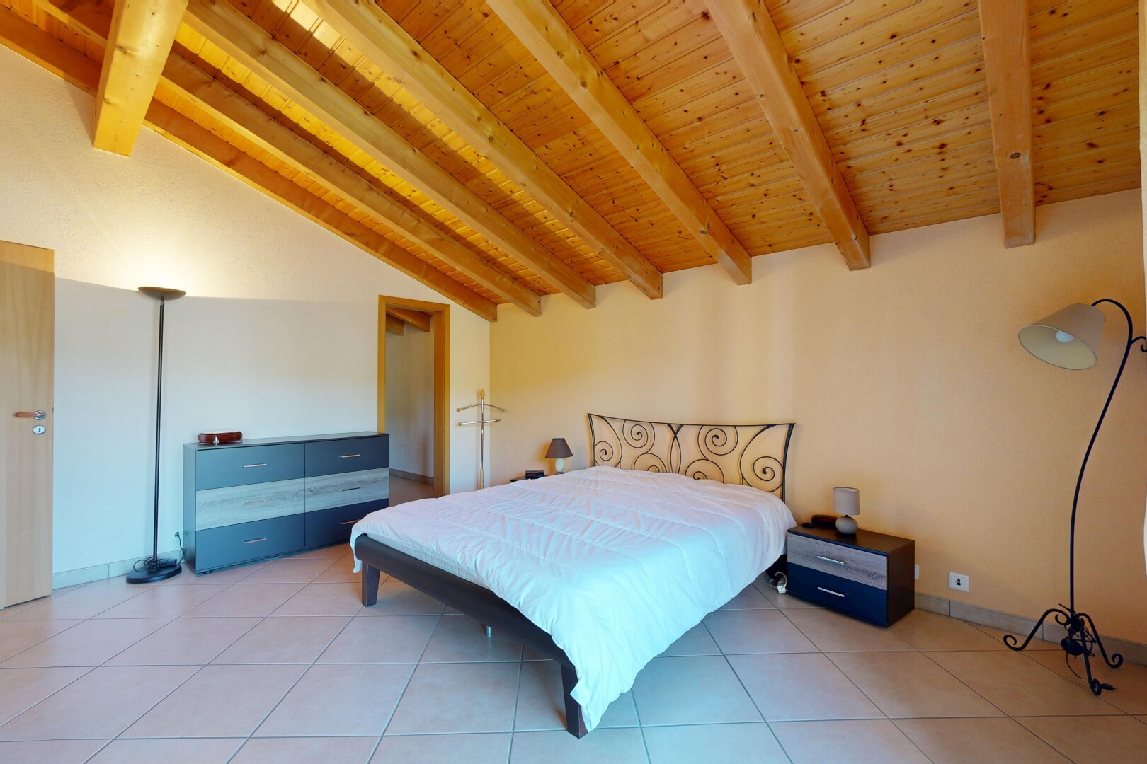 room featuring vaulted ceiling with beams, wooden ceiling, and light tile patterned flooring
