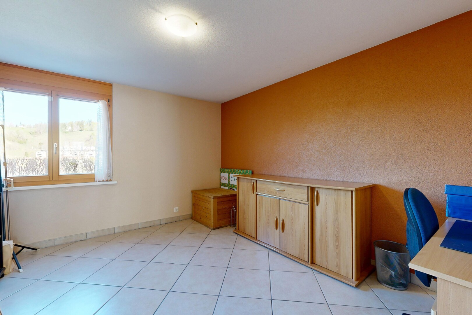 unfurnished room featuring a desk and light tile patterned floors