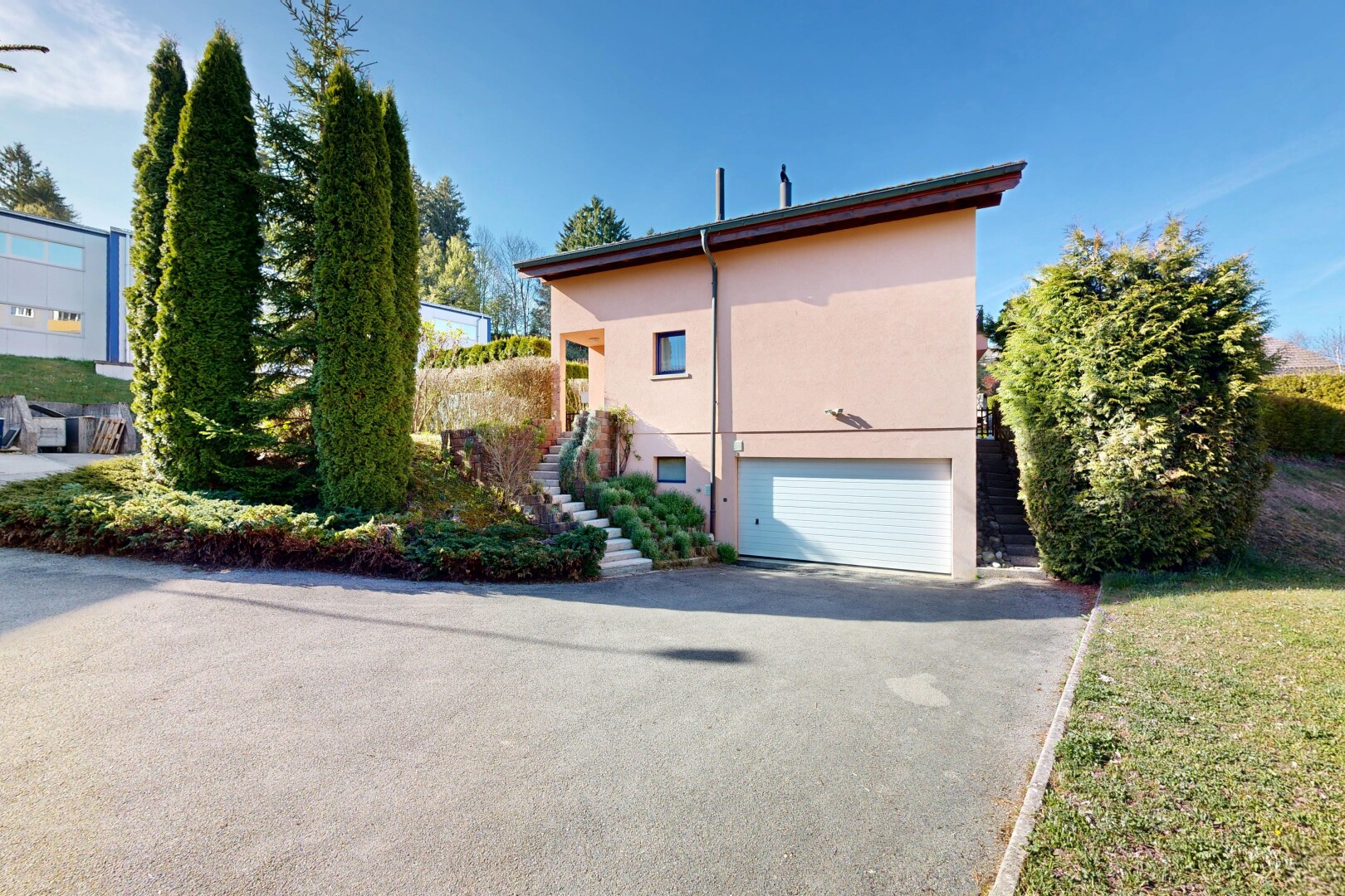 view of home featuring an attached garage, asphalt driveway, and stucco siding