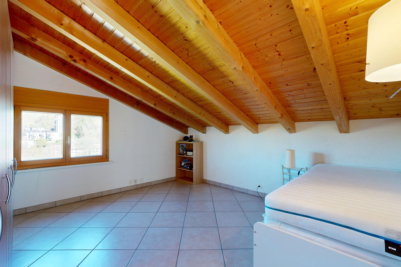 room / bedroom with light tile patterned floors and lofted ceiling with beams