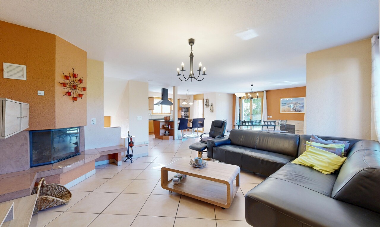living area with hanging lights, plenty of natural light, and light tile patterned floors