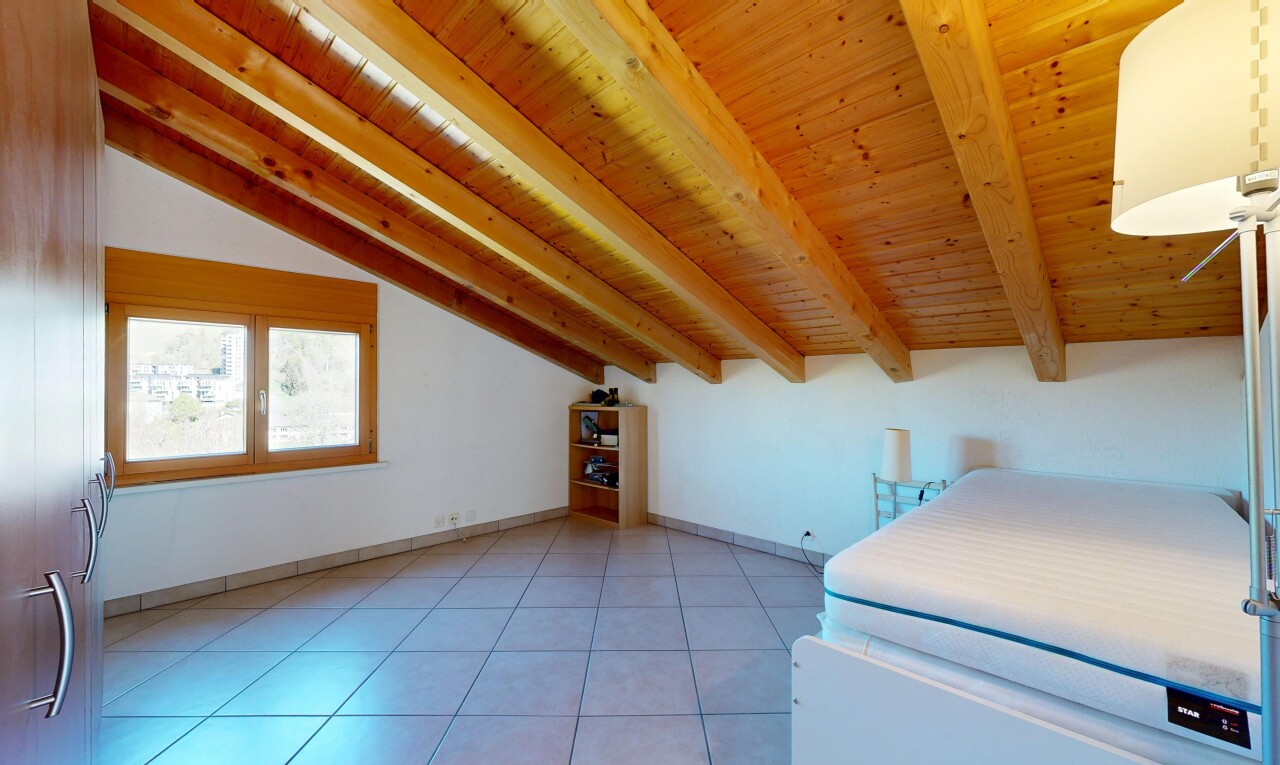 room / bedroom with light tile patterned floors and lofted ceiling with beams
