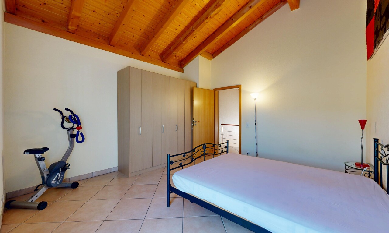 room / bedroom featuring a high wood beamed ceiling, a closet, and light tile patterned floors