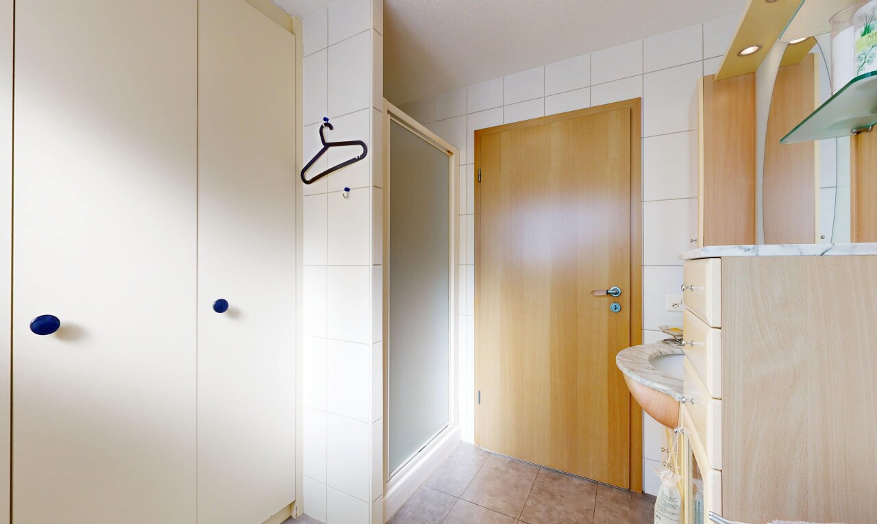full bathroom with a stall shower, light tile patterned flooring, vanity, and recessed lighting