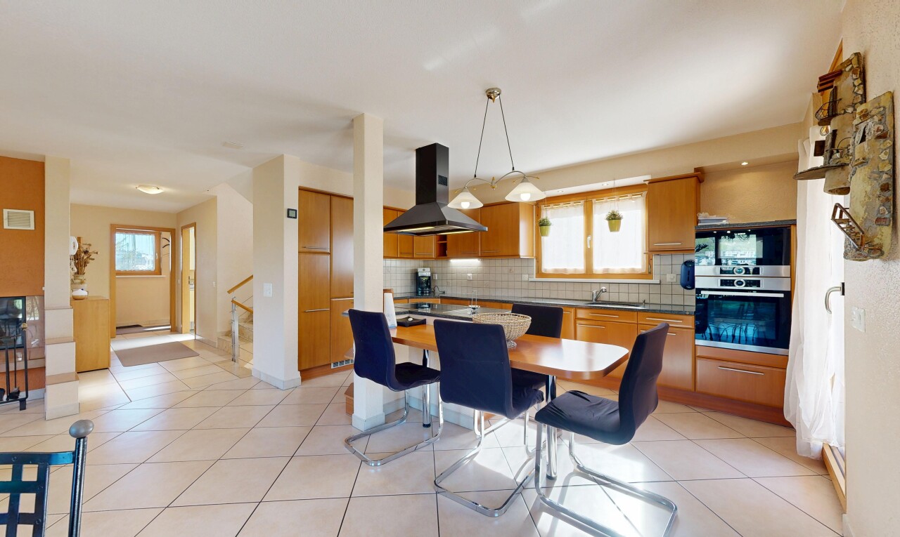 kitchen featuring stainless steel appliances, range hood, tasteful backsplash, and wood finish cabinetry