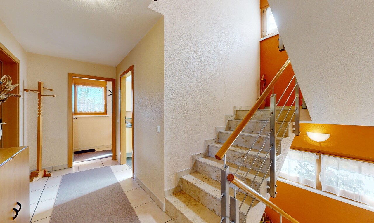 staircase featuring plenty of natural light and tile patterned flooring